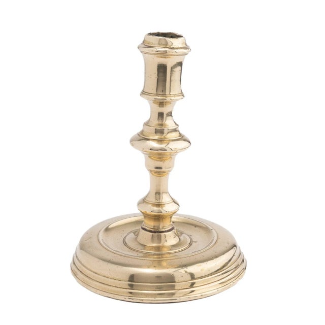 Cast brass baluster shaft & candle cup candlestick threaded to a circular base France, circa 1720.