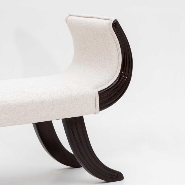 Elegant bench in classic form with ebonised u-shaped frame and white bouclé cover. The bench has been newly upholstered...