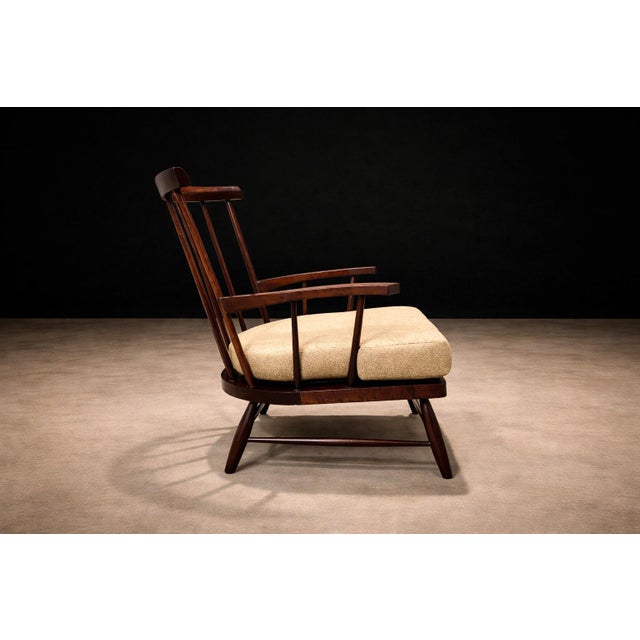 A sculptural Brazilian modern armchair by A Forma Decorativa, executed in richly toned solid imbuia hardwood, one of...