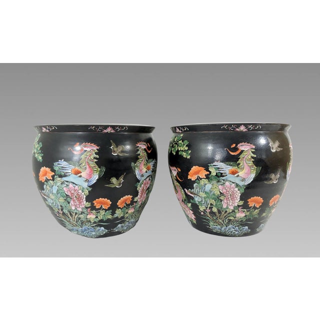A rare pair of older Chinese Famille Noire Nyonya ceramic planters. These magnificent hand painted planters have a wrap...