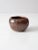 This vintage studio pottery bowl features an earthy brown glaze with subtle red undertones and a soft metallic sheen from...