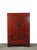 This Chinese antique cabinet shows striking muted aged rich red and stands 66.3 inches tall. The traditional brassware...