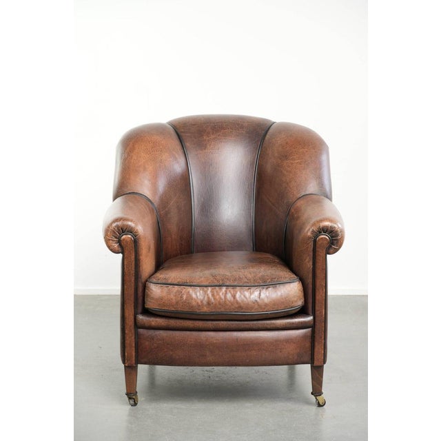 This characterful vintage sheepskin armchair features a comfortable seat, a unique design, and a timeless appearance. It...