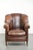 This characterful vintage sheepskin armchair features a comfortable seat, a unique design, and a timeless appearance. It...