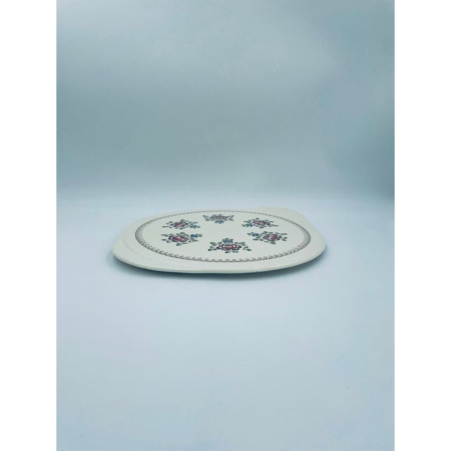 A vintage-style cake stand, crafted from high-quality ecru ceramic. The round stand, with two integrated, contoured...