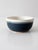 This is a vintage studio pottery bowl. Signed by the artist, the handmade ceramic bowl features a rich blue and creamy...