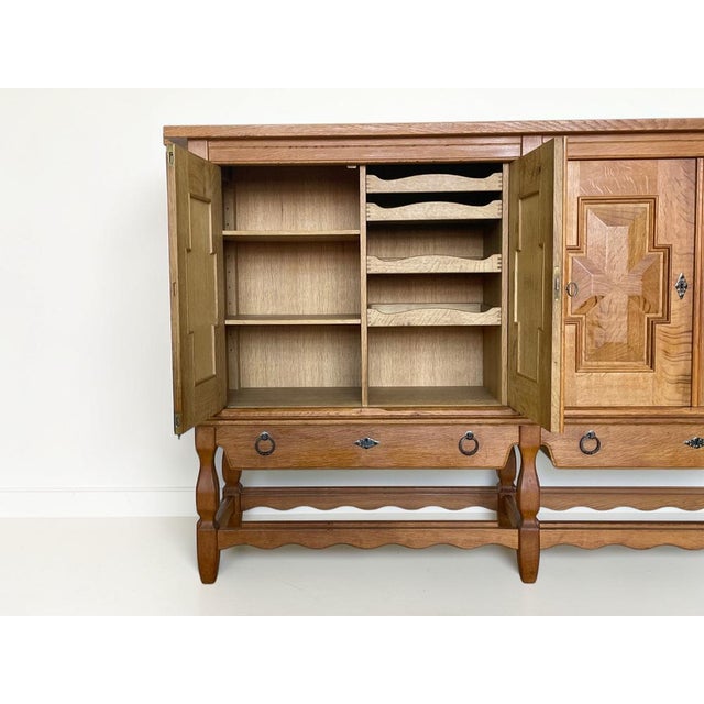 A sculptural Danish mid-century sideboard designed by Henning (Henry) Kjærnulf and produced by Nyrup Møbelfabrik in the...