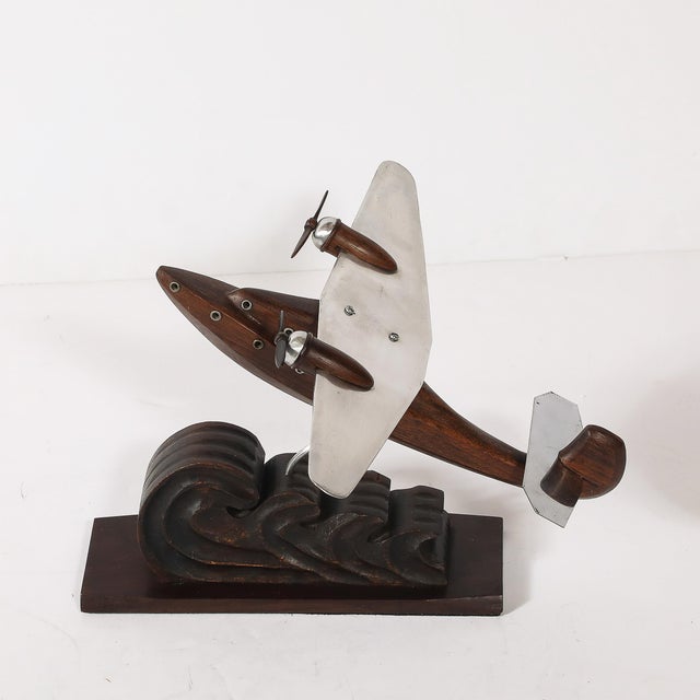 This Art Deco sea plane sculpture, designed by Anthoine Art Bois in France circa 1930, is an exquisite fusion of...