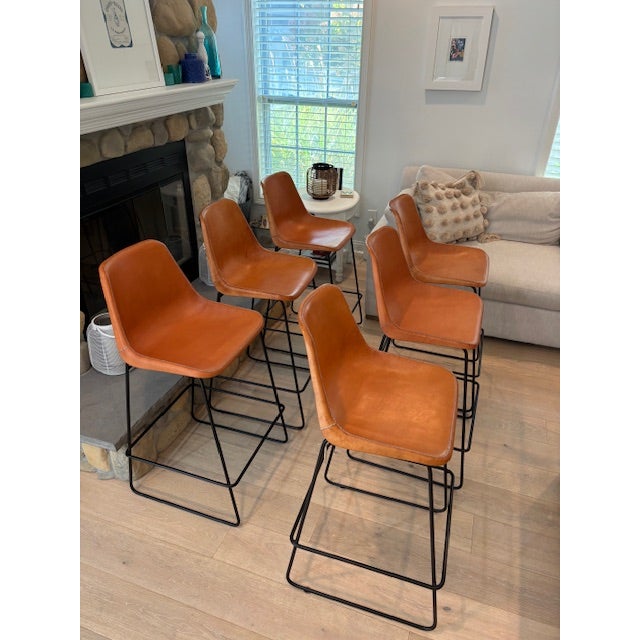 Pairing warm, handmade Paraguayan leather with a sleek iron frame, this handsome seat is ready to lend itself to almost...