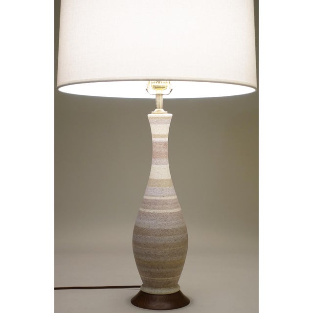 An impressive and dramatic ombre-like lava glaze "Bottle" form Mid Century Modern Ceramic Pottery table lamps designed by...