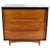 An elegant dresser in teak with an ebonized frame. It has four spacious drawers with handles that are incorporated curved...