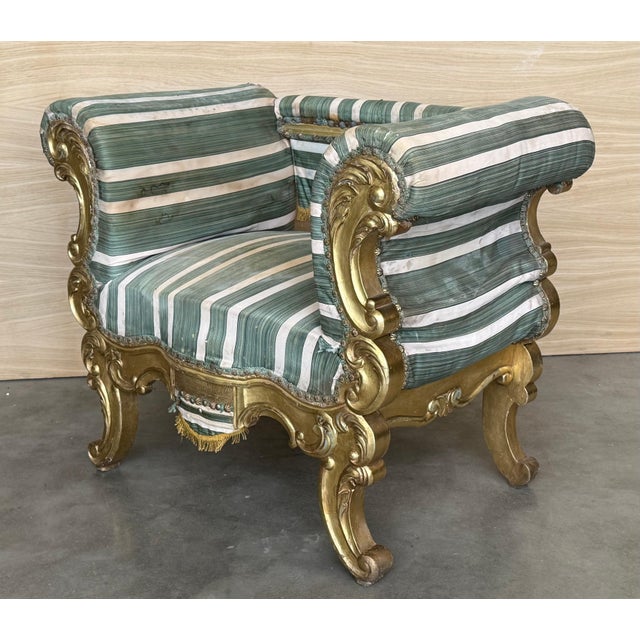 An exquisite French 19th century giltwood armchair. This one-of-a-kind piece has every curve of the carved wood frame...