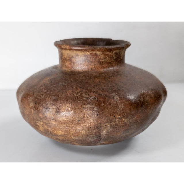 We are selling this great early Pre-Columbian pottery vessel. This vessel has squat squash form with red pottery body and...