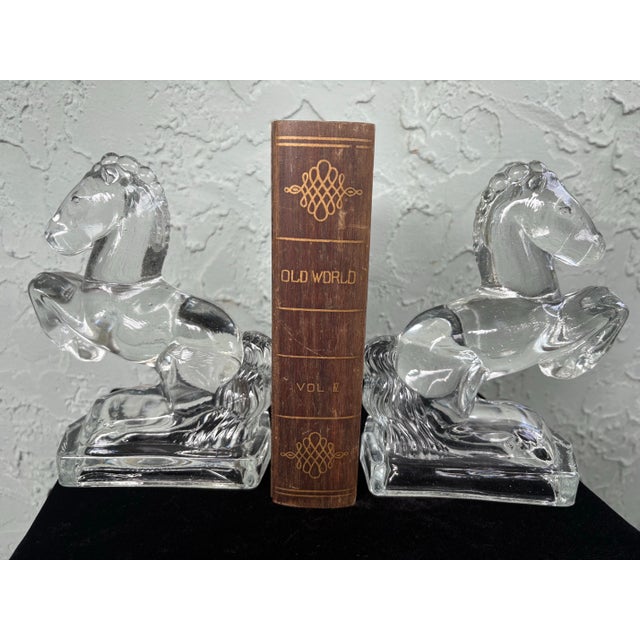 Bring a touch of mid-century American glass artistry to your shelves with this striking pair of vintage L.E. Smith rearing...
