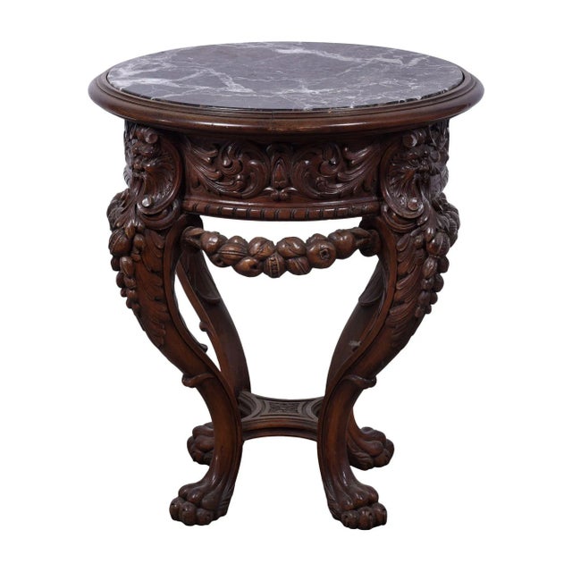 Antique marble top carved plant stand, circa 19th century. This heavily detailed plant stand features carvings including...