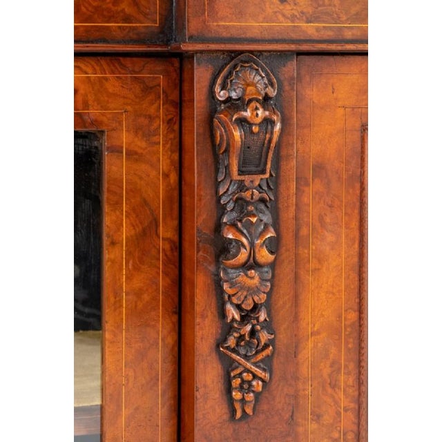 Victorian Burr Walnut Credenza. Standing Upon a Plinth Base. Circa 1860 The Central Glazed Door is Flanked by Pillars with...