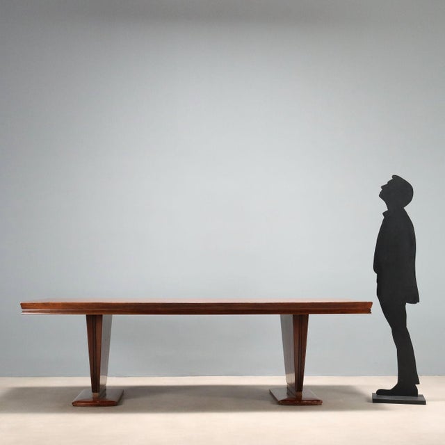 A generously sized executive table that can also be used as a dining table. It features a rectangular wooden top with an...