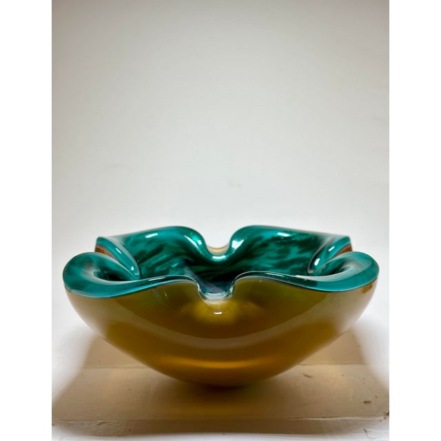 MCM Murano attributed glass ashtray/dish with a striking translucent emerald green with a deep yellow vase. The piece has...