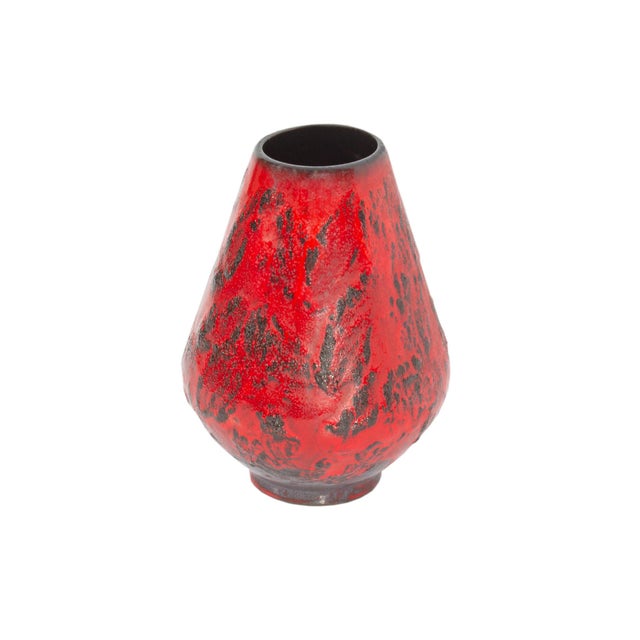 A West German ceramic vase produced by Gräflich Ortenburg. This mid-century vase features a bright red glaze and a tapered...