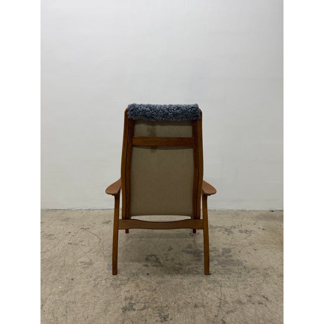 Lamino arm lounge chair with blue-gray sheepskin fabric on a teak wood frame by Yngve Ekström for Swedese, 2000s.