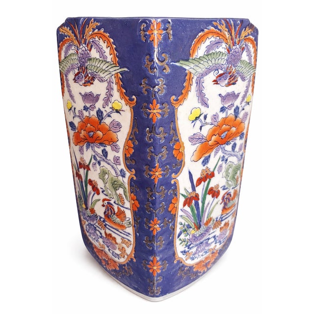 A striking vintage Chinese porcelain vase featuring a deeply saturated cobalt blue ground adorned with vibrant orange...