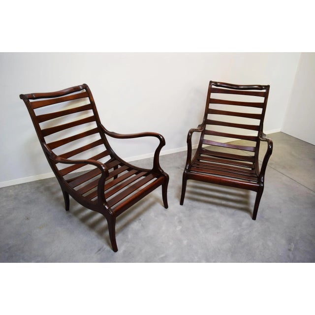 This pair of armchairs with a dark walnut structure was produced in the style of Paolo Buffa in Italy in 1958. The pieces...