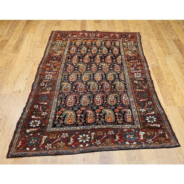 "Be enchanted with the whimsical charm and exceptional artistry of this vintage Persian Kurdish area rug from the late...