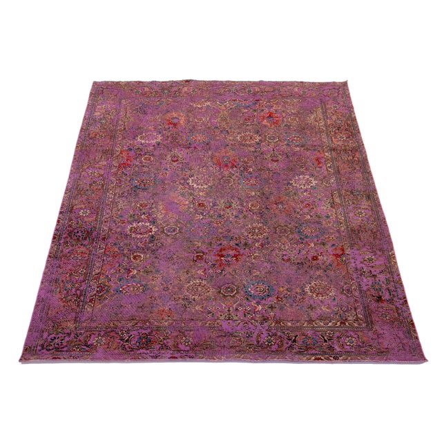 This antique purple Persian wool rug showcases a beautiful floral design with vibrant multicolor accents. This rug...