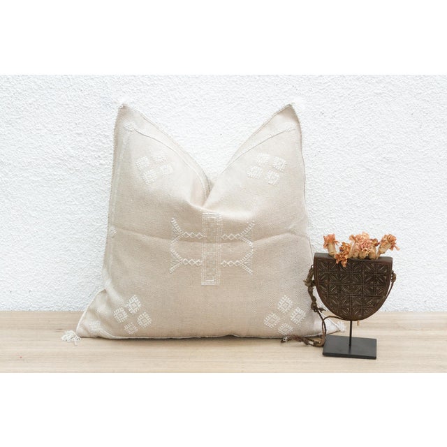 Indulge in the subtle beauty of our handcrafted Moroccan cactus silk pillow, measuring approximately 22 inches square....