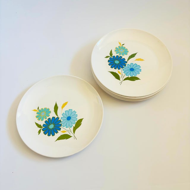 A set of 6 mid century ceramic dinner plates by American Ironstone. Glossy white glaze with a pattern of blue flowers on...