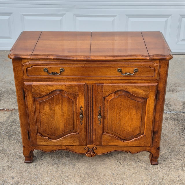 This is a French country style server or buffet by high-end American furniture maker Ethan Allen from its 1980s Country...
