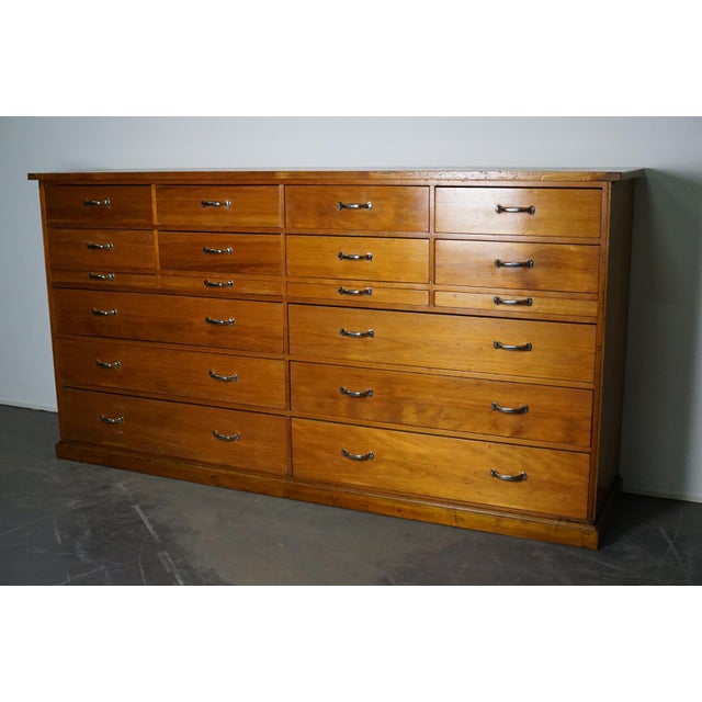 This apothecary cabinet was made circa 1950s in the Netherlands. It features 18 drawers with nice chrome handles. It...