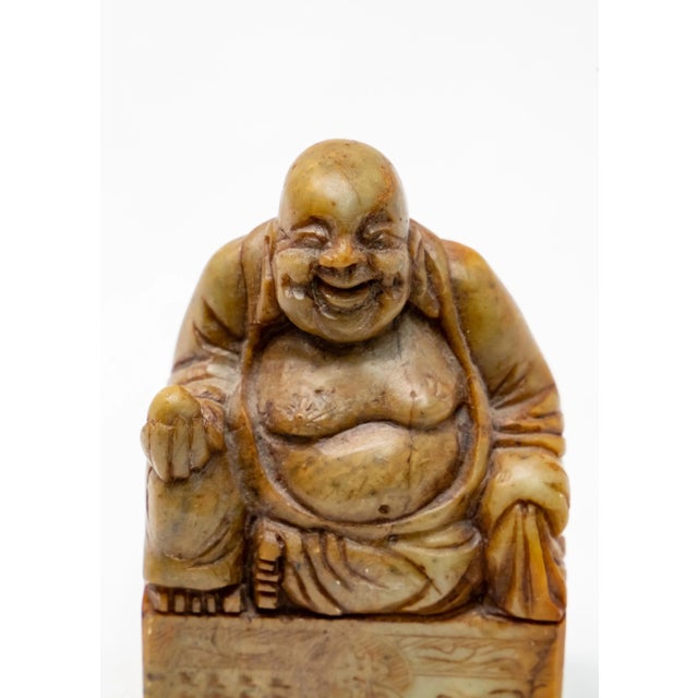 Offering this impressive soapstone chop seal. The top depicts a Shoushan Buddha holding an egg shaped stone in one hand....