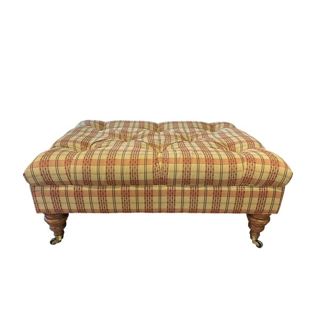 Add timeless English country charm to your home with this generously proportioned tufted ottoman featuring warm plaid...