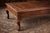 This elegant coffee table features a richly detailed leather inset top adorned with a vintage-style world map motif,...