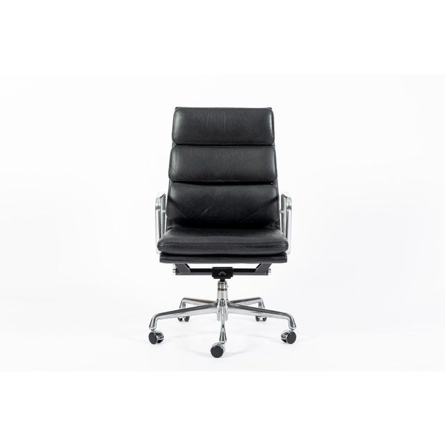 This authentic Eames for Herman Miller Soft Pad Executive Height black leather office chair from the Aluminum Group...