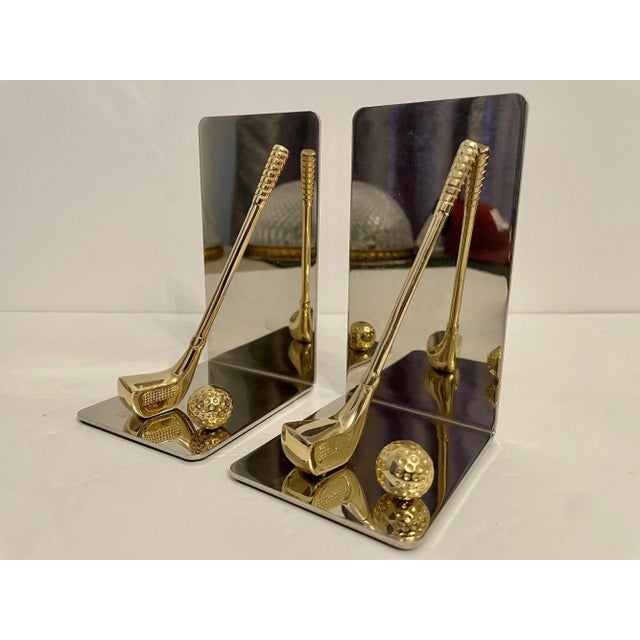 Set of brass and chrome golf bookends featuring brass club and ball with nice detail. Thin foam on bottom to prevent...