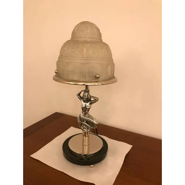 French Art Deco Mermaid table lamp by Genet et Michon. Having clear frosted glass with over flowing floral motif details....