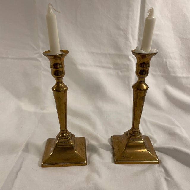 A pair of English Georgian Brass candlestick holders with push-up bottoms