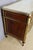 A Louis XVI mahogany commode from the late 18th century. It features three large drawers and rests on four toupie feet....