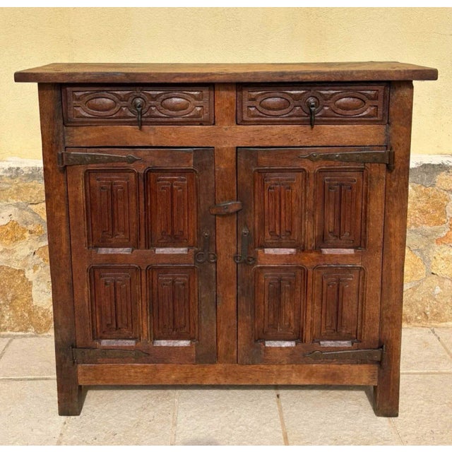 from Northern Spain, constructed of solid walnut, the rectangular top with molded edge atop a conforming case housing two...