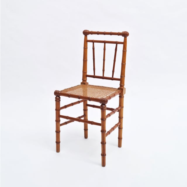 A pair of American Victorian faux bamboo side chairs with cane seats, dating to circa 1880, offered in their original...