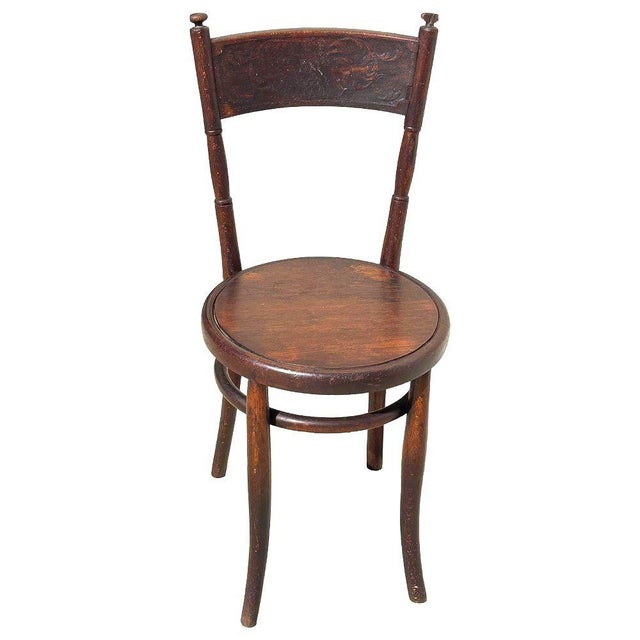 Victorian sculpted oak side chair with a carved Backrest by Jacob & Josef Kohnfeaturing an elegant, sculptural frame...