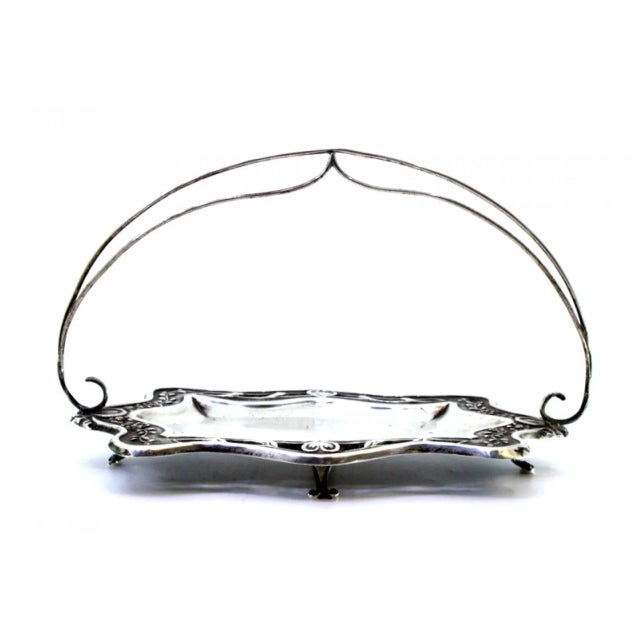 Cut-Out Silver Ring with Double Handle, in Very Good conditions. Designed 1890 to 1919 This piece has an attribution mark,...