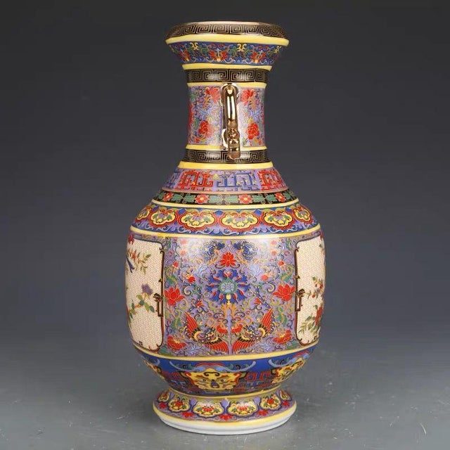 This magnificent vase features a classic baluster form with a flared rim, a distinct neck, and a sturdy foot. It is a...