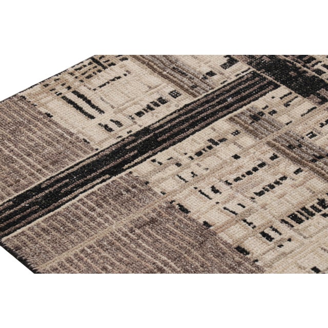 Hand-knotted in wool, this 6x9 modern rug, originating from India, featuring geometric patterns in a fabulous design of...