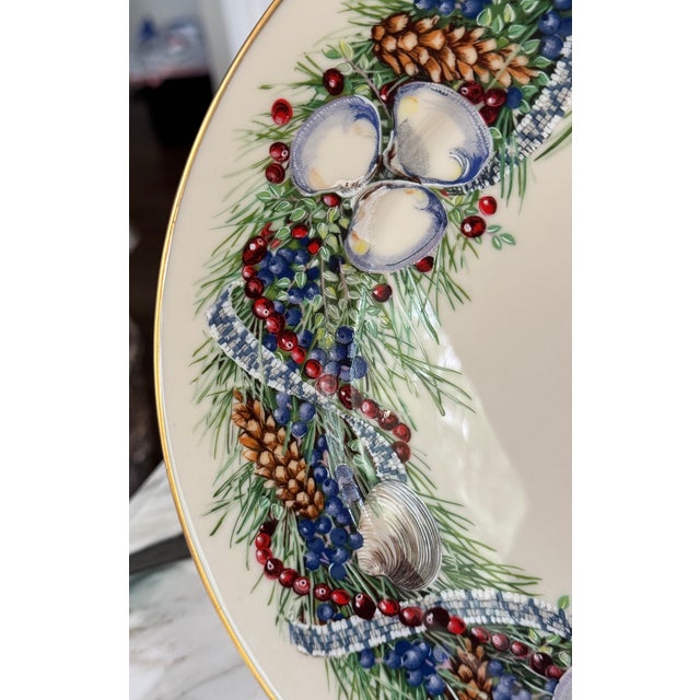 1984 in the Lenox annual Colonial Christmas Wreath Series. Gold gilt border on the recognizable creamy white background of...