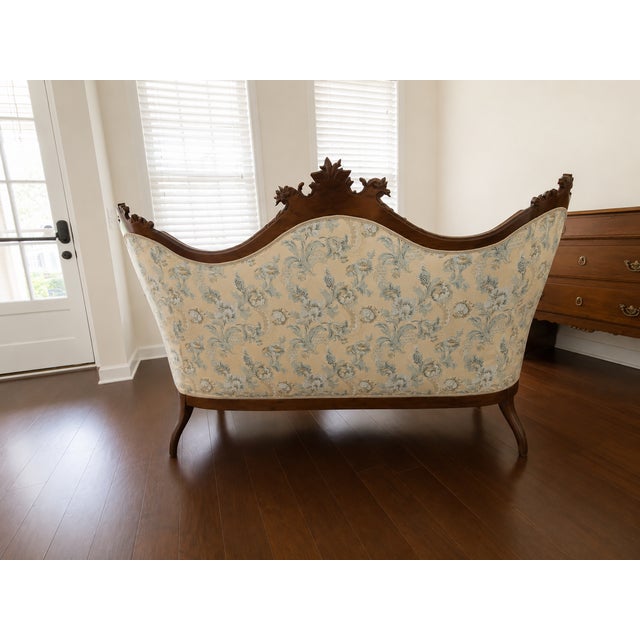 A stunning 19th-century Rococo Revival sofa from Genoa, Italy, with a richly carved walnut frame. The serpentine crest...