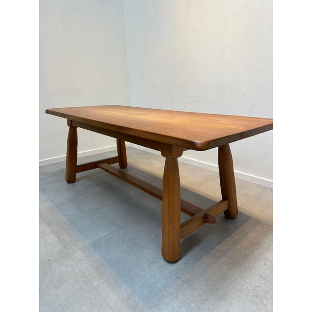 A beautifully crafted mid-century dining table set made entirely from solid oak. This elegant yet robust piece features a...
