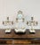 Quality antique Victorian clock garniture with a pair of candelabras standing on onyx bases with ornate brass mounts...